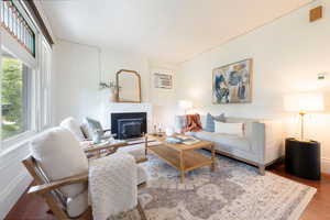 Living room with healthy amount of natural light, wood finished floors.