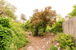 View of yard featuring fence