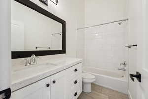 Bathroom featuring shower / bathtub combination, toilet, vanity, and wood finished floors