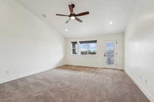 Empty room with carpet, baseboards, recessed lighting, ceiling fan, and vaulted ceiling