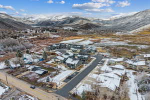 Snowy aerial view featuring a residential view and a mountain view