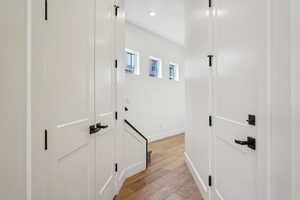 Hallway with recessed lighting, baseboards, and light wood-style floors