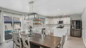 Dining room with light wood-type flooring, visible vents, and recessed lighting