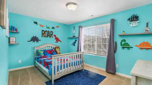 Bedroom with visible vents, baseboards, and carpet floors