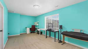 Carpeted office space with baseboards and visible vents