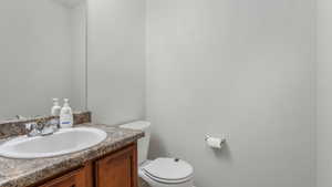 Half bathroom with vanity and toilet