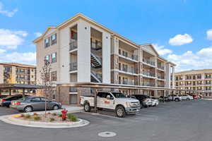 View of building exterior with covered parking