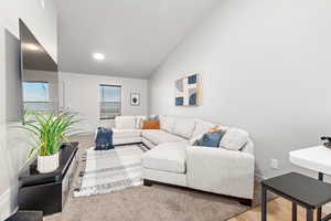Living area featuring lofted ceiling and wood finished floors