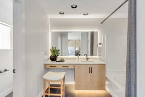 Full bath with shower / bath combination, vanity, and tile patterned flooring