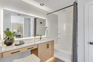 Full bath featuring tile patterned floors, visible vents, vanity, and bathing tub / shower combination