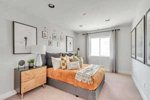 Bedroom featuring recessed lighting, baseboards, and light carpet