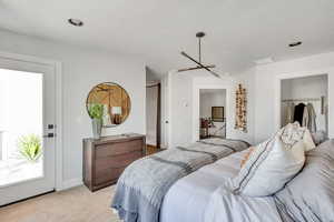 Bedroom featuring light colored carpet
