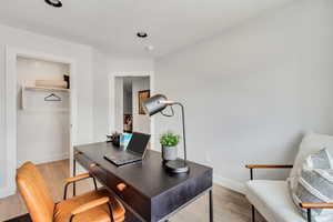 Office area with light wood finished floors and baseboards