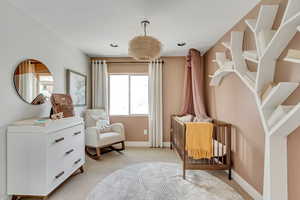 Sitting room with baseboards and light carpet