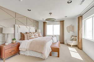 Bedroom with recessed lighting, visible vents, and light colored carpet