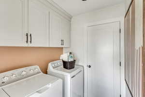 Laundry area with washer and dryer and cabinet space
