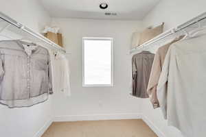 Spacious closet with visible vents and carpet