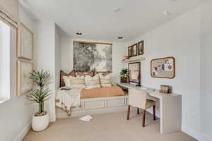 Carpeted bedroom featuring baseboards