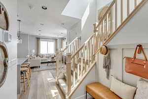Stairway with recessed lighting and wood finished floors