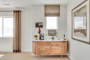 Bar with light carpet, visible vents, and baseboards
