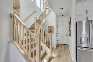 Staircase featuring baseboards and wood finished floors