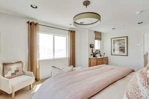Bedroom with recessed lighting and light colored carpet