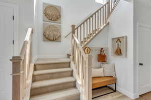 Stairs featuring baseboards and wood finished floors