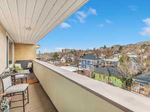 Covered balcony with a mountain view and a residential view