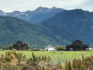 View of mountain backdrop featuring rural landscape