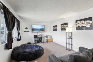 Interior space featuring baseboards and a textured ceiling