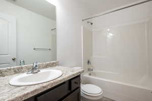 Full bathroom with visible vents, vanity, toilet, and washtub / shower combination