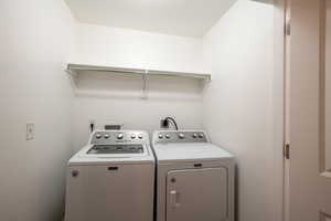 Washroom with separate washer and dryer and laundry area