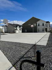 Exterior space featuring a residential view and community basketball court