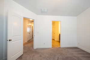 Unfurnished bedroom featuring carpet, visible vents, and baseboards