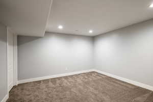 Finished basement with recessed lighting, baseboards, and carpet floors