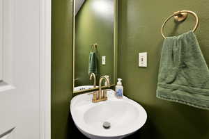 Bathroom featuring a sink and a textured wall