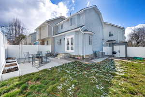 Back of property featuring a patio area, entry steps, french doors, and a fenced backyard