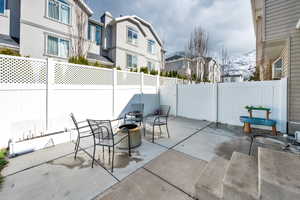 View of patio with a residential view, an outdoor fire pit, and a fenced backyard