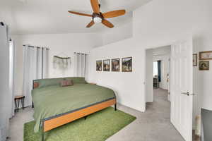 Bedroom with lofted ceiling, baseboards, carpet floors, and ceiling fan