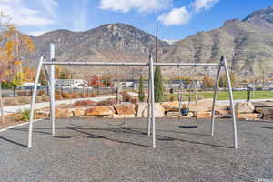 Community play area with a mountain view and fence