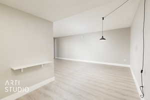 Spare room with light wood-style floors and baseboards