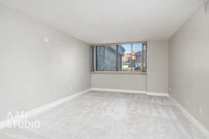 Master bedroom with carpet flooring, visible vents, baseboards, and a textured ceiling