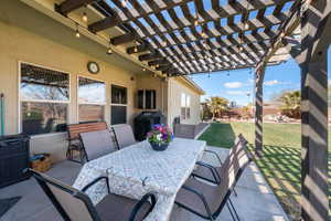 View of patio featuring outdoor dining area, area for grilling, and a pergola