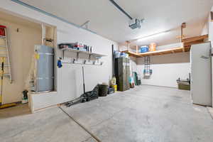 Garage with secured water heater and a garage door opener