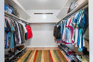 Spacious closet with wood finished floors