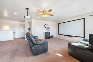 Cinema room featuring recessed lighting, a textured ceiling, ceiling fan, and carpet floors