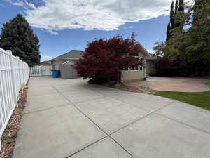 View of home's exterior with a patio and concrete driveway