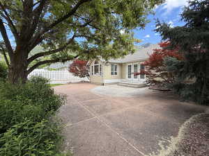 Rear view of house with french doors, a patio area, and stucco siding