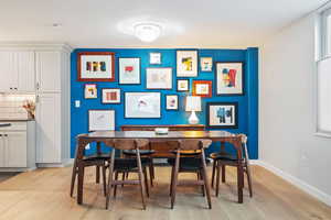 Dining space with light wood finished floors and baseboards