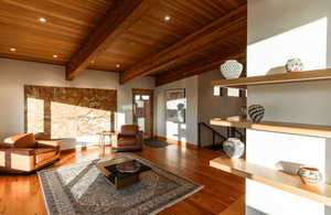 Living area featuring baseboards, beamed ceiling, wood ceiling, recessed lighting, and wood finished floors